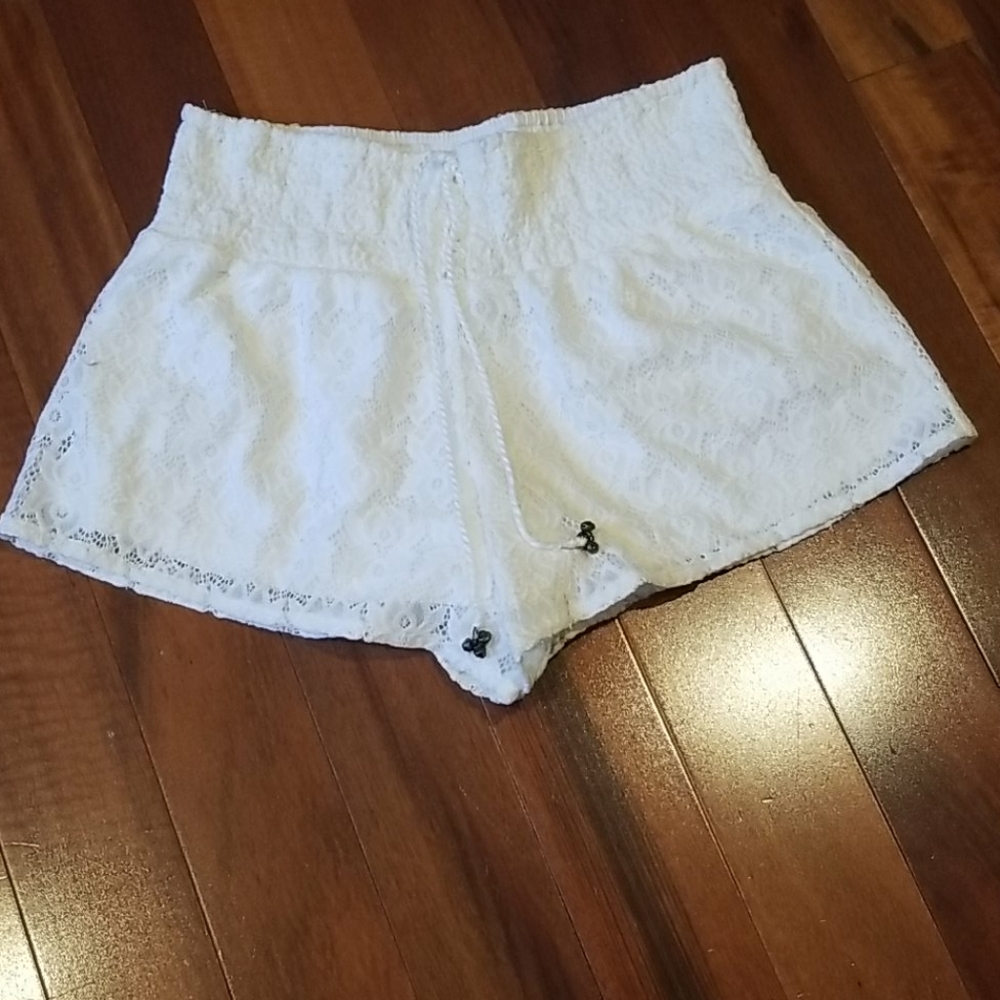 Fully lined white lace shorts.